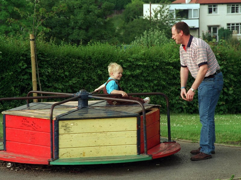 Joe Geekie with his son Joseph enjoying a ride on a roundabout at Springhead Park in June 1997.