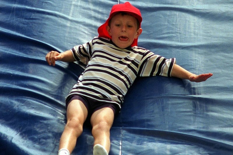 Daniel Newton keeps fully concentrated while on the fun slide at Rothwell Carnival in July 1997.