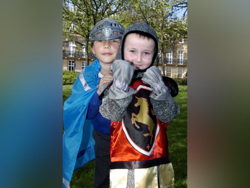 Ashley Anderson and Callum White dress up as medieval knights at a holiday workshop.