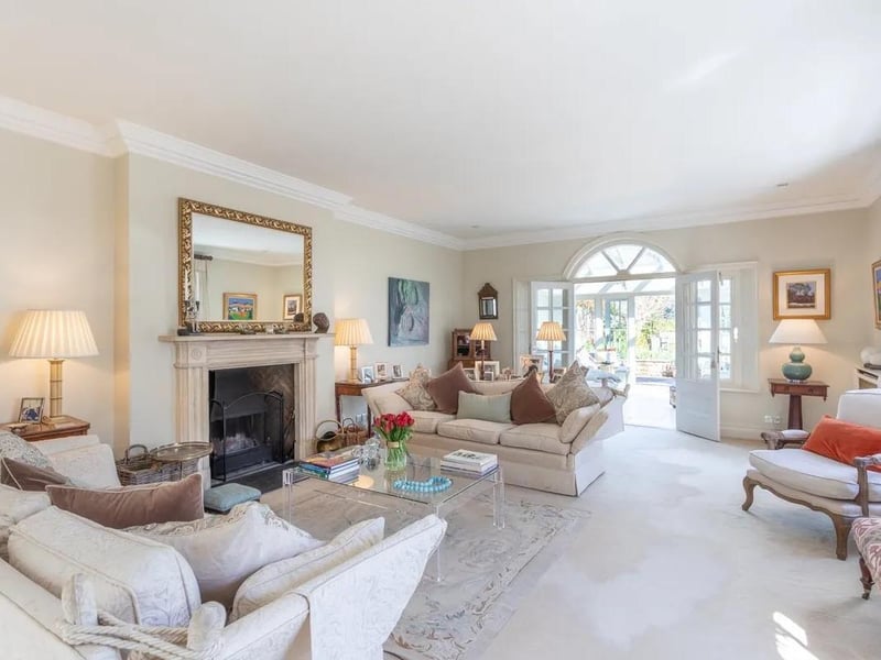 A large and comfortable lounge with focal fireplace and double doors