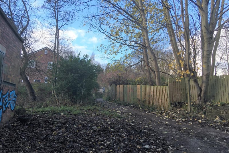 At the T-junction of footpaths at the end of the Highbury ginnel, the left path is the bottom of another old track to Wood Mill (pictured), known as School Lane. Go up School Lane, with the mill pond behind a wooden fence on your right, until you come to a footpath crossroads. Go straight across the crossroads, and continue on the old track into the middle part of School Lane, between hedges. Exit onto the top of Highbury Mount, and cross diagonally right to the entrance to the final part of School Lane.
