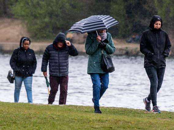 People out for a rainy walk in Roundhay Park on Bank Holiday Monday.