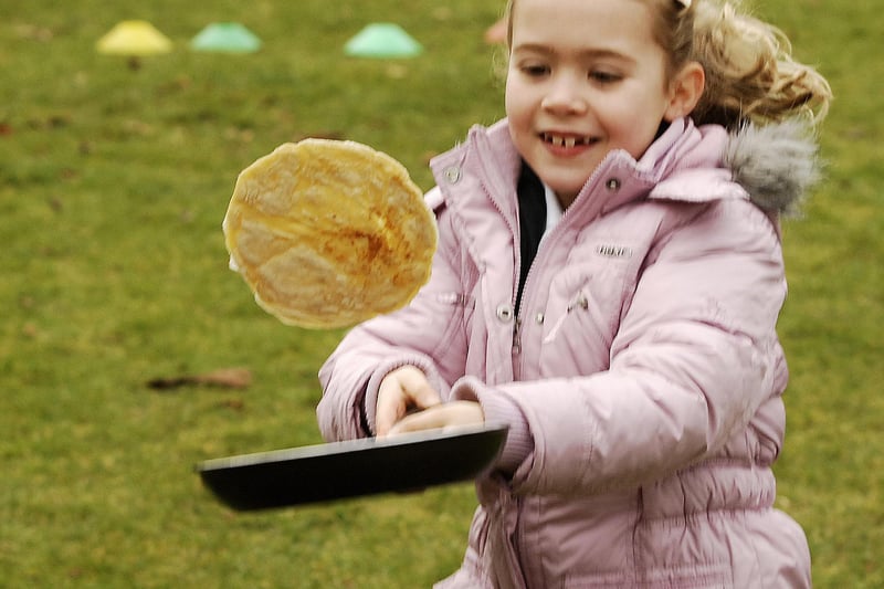 Children from Wedderburn Primary School take part in a pancake race outside Christchurch on the Stray.
