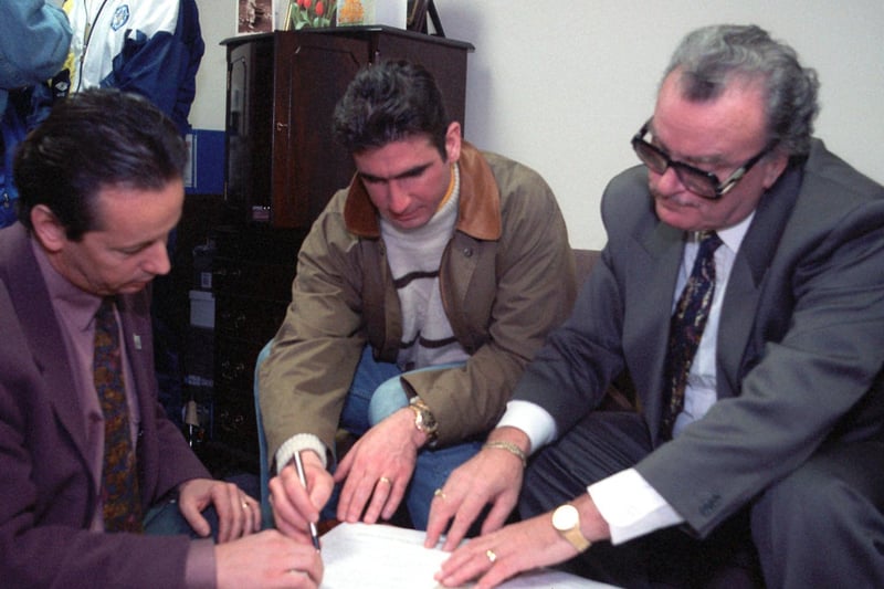 Eric Cantona signs for Leeds United in February 1992. He is picured with managing director Bill Fotherby (right) and his agent.