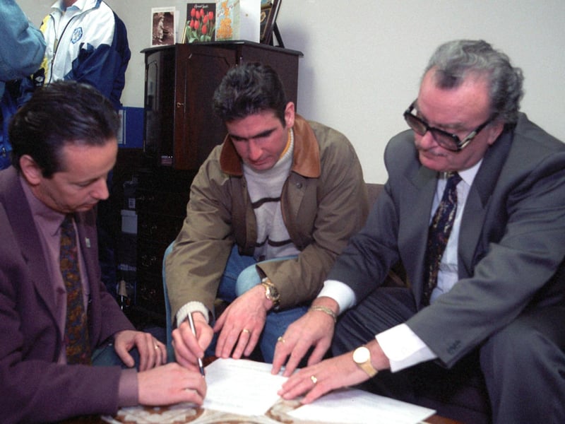Eric Cantona signs for Leeds United in February 1992. He is picured with managing director Bill Fotherby (right) and his agent.