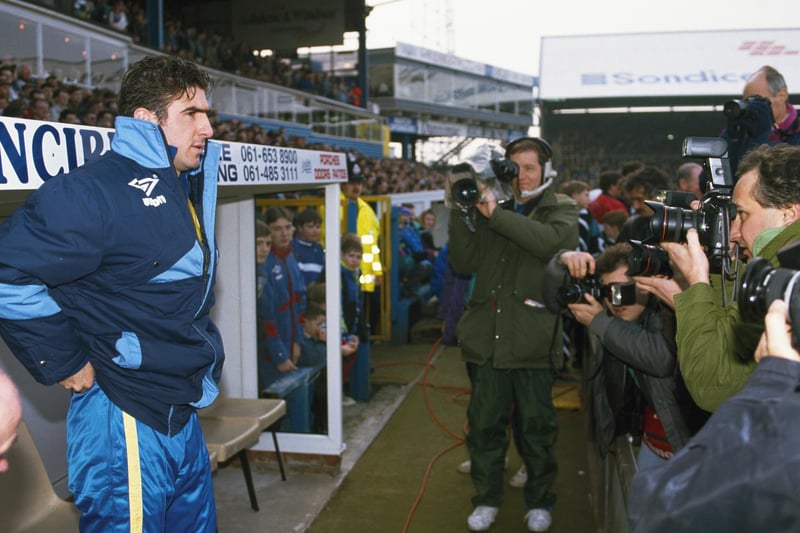 Substitute Eric Cantona looks on from the bench prior to making his Leeds United debut during the League Division One clash against Oldham Athletic at Boundary Park in February 1992.