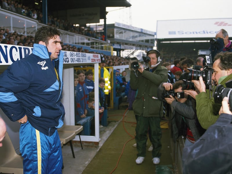 Substitute Eric Cantona looks on from the bench prior to making his Leeds United debut during the League Division One clash against Oldham Athletic at Boundary Park in February 1992.