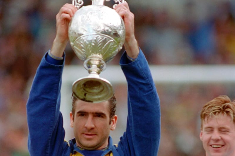 Eric Cantona lifts the First Division trophy.