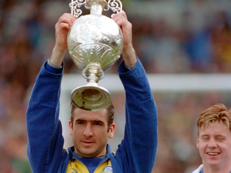 Eric Cantona lifts the First Division trophy.