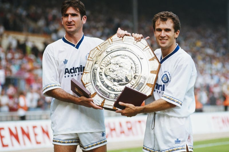 Hat-trick hero Eric Cantona and fellow goalscorer Tony Dorigo pose with the Charity Shield trophy after Leeds United beat Liverpool 4-3 at Wembley.