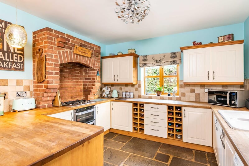 The traditional country-style kitchen is fit with integrated appliances.