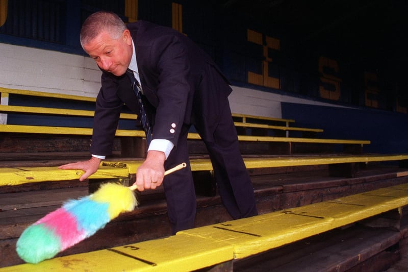 Guiseley Football Club secretary Alan Walker dusts off the ground's seats to launch the club's new executive packages in January 1997.