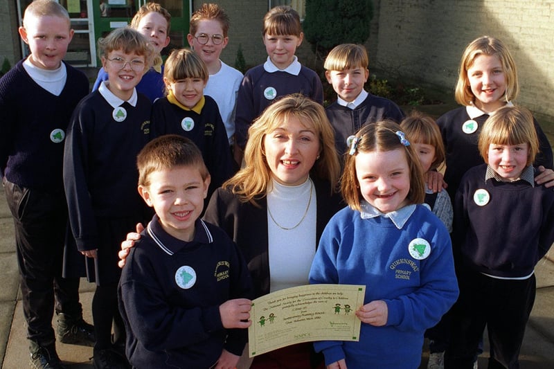Queensway Primary School raised more than £500 for the NSPCC in February 1997. Pictured is Sharon Harrison from the charity handing over a certificate of thanks to pupils.
