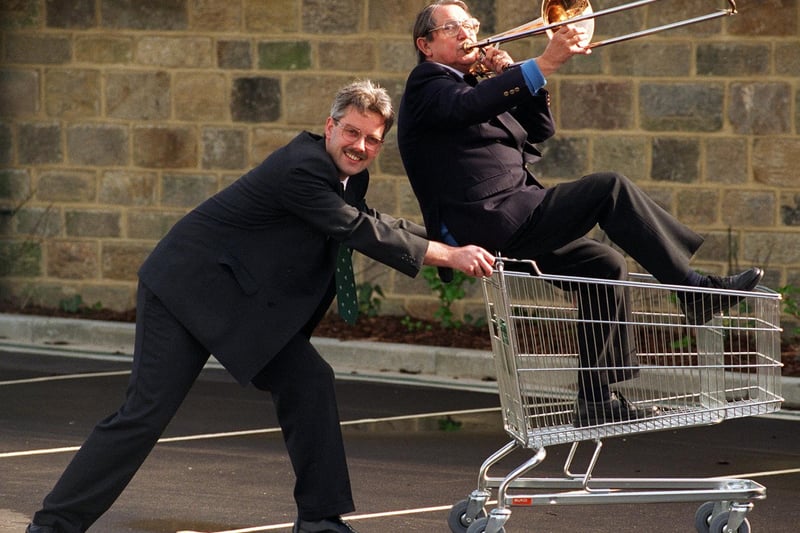 Store manager, Atholl Robertson, of newly-opened Booths supermarket rushes Guiseley Brass member Jeff Blakeson to join the rest of the band to celebrate the opening.