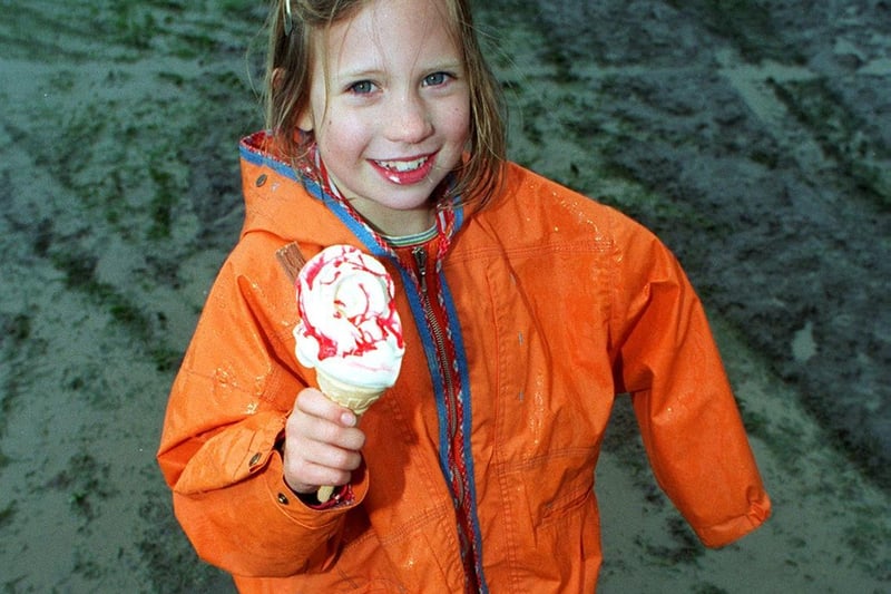 No stick in the mud. Young Tiffany Lund enjoys her ice-cream despite the wet weather at the Ilkley Carnival.