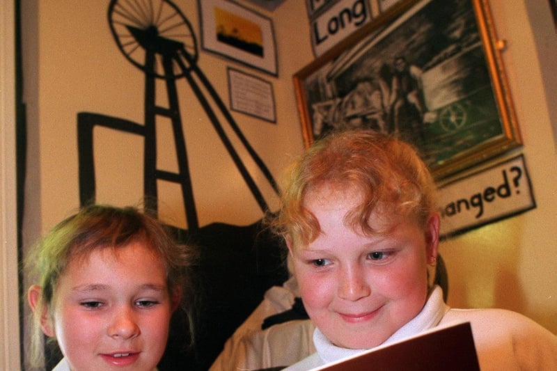 Westwood Primary School pupils Jamesinna Watt (left) and Gayle Hughes look at a book on the community as part of their class's 'old Middleton project'.
