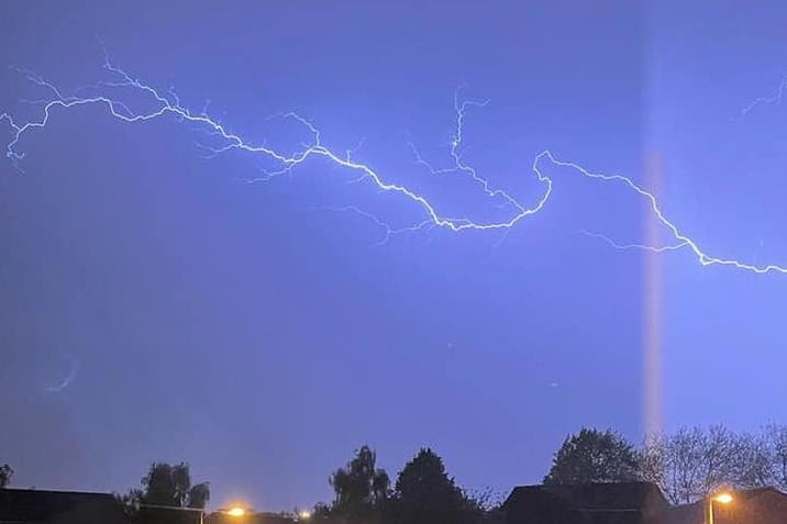 Tracy Goodwin sent in this incredible photo of lightning flashing over her street.