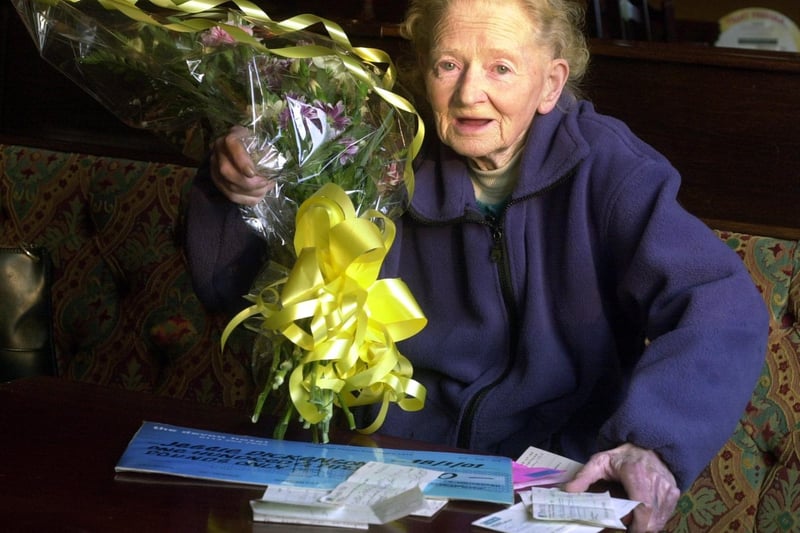 Crime victim and pensioner Jessie Dickinson receives flowers and cheques at the Devon pub in Cross Gates.