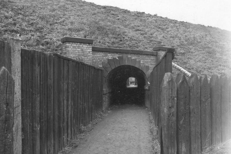 Wooden fences to left and right of a passageway leading to an underground subway underneath the Leeds, London, Midland and Scottish railway bridge on Gelderd Road, Hunslet in October 1940.

Photo: Leeds Libraries, www.leodis.net