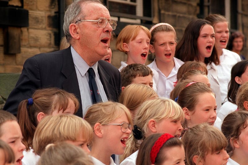 Lord Meryvn-Rees sings with children from Newlands Primary after the naming of Mervyn-Rees Avenue in Morley in July 1997.