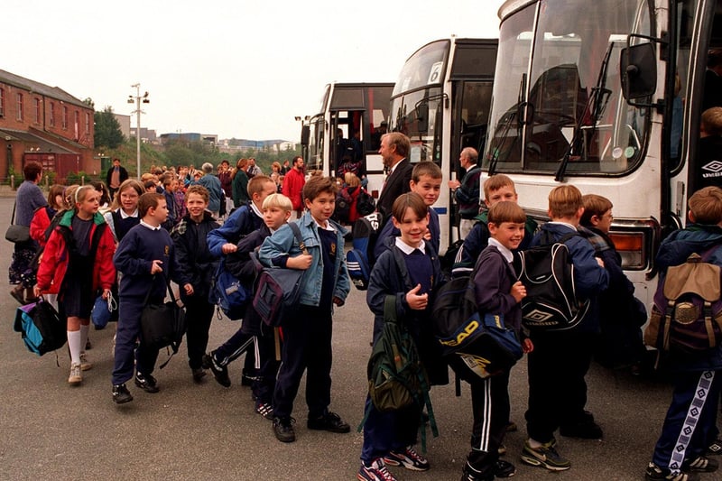 Morley Victoria Primary School pupils boarding coaches at Morley Snooker Centre for the journey to Sharp Lane School in Middleton.