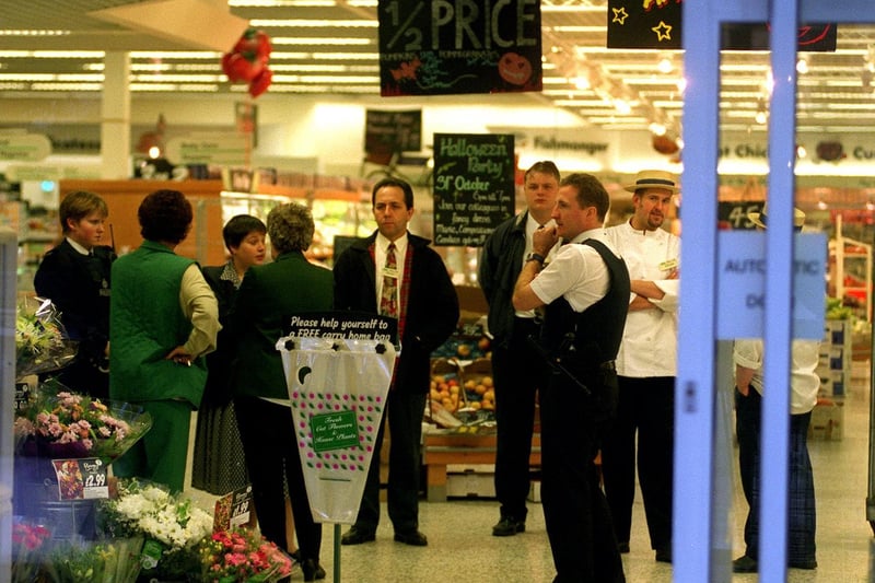 Police and shocked staff in the ASDA store at Morley after the armed raid in October 1997.