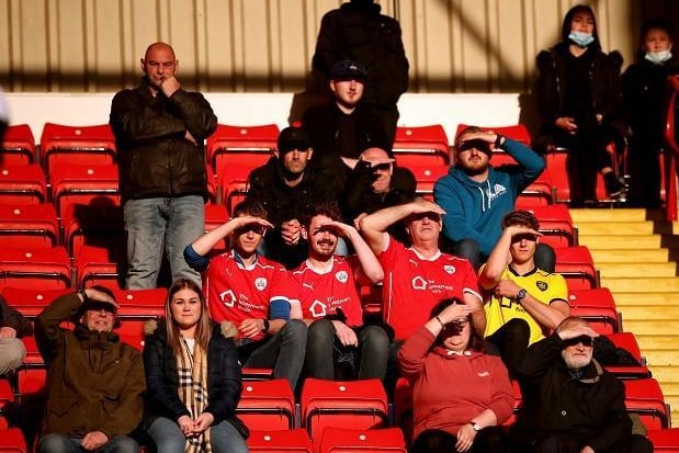 Barnsley's fan contend with the evening sun at Oakwell on Monday night.