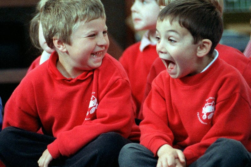 Featherbank Lane Infant School pupils Phillip Withan and Oliver Glover laugh
during a performance of How High Is Up by the West Yorkshire Playhouse Schools Company.