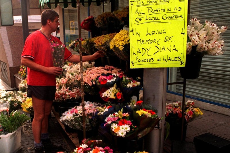 September 1997 and a flower seller prepares his city centre stall.