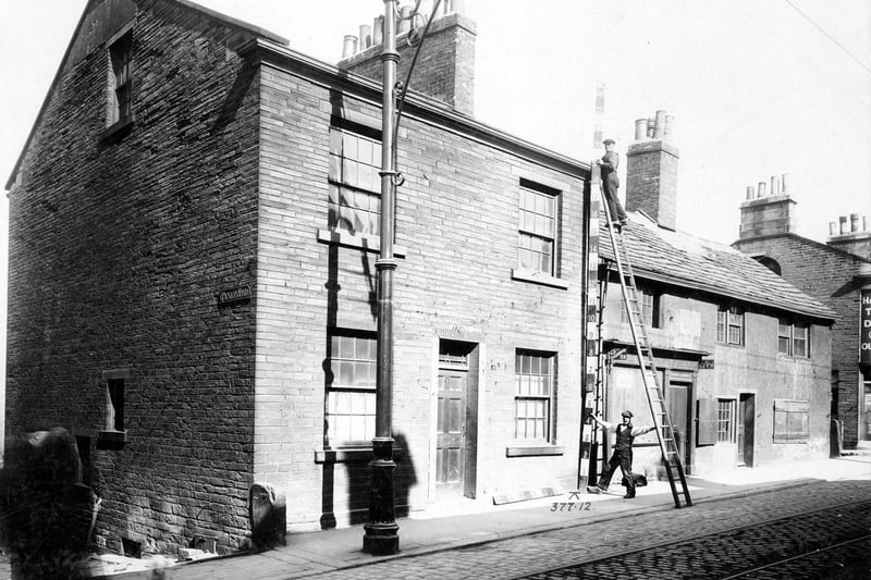 May 1909 and to the left is Pickles Yard, then Town Street. The property is being measured prior to demolition. It was part of a plan to improve Town Street.