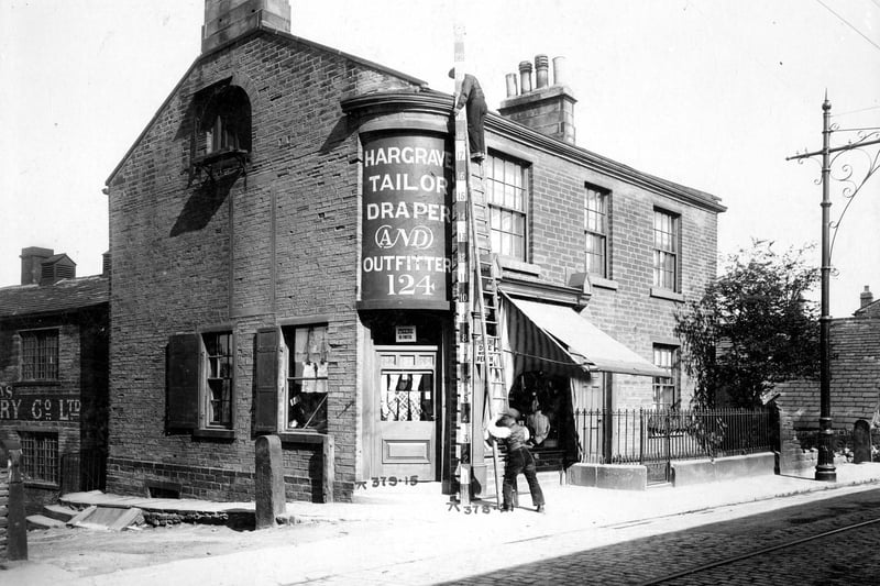 May 1909 and pictured on Town Street is drapers shop and house business of Joseph. H. Hargrave. Workmen are measuring the property as part of an improvement plan for Bramley Town Street.