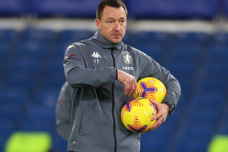 Aston Villa's English assistant coach John Terry collects up the balls ahead of the English Premier League football match between Chelsea and Aston Villa at Stamford Bridge in London on December 28, 2020.