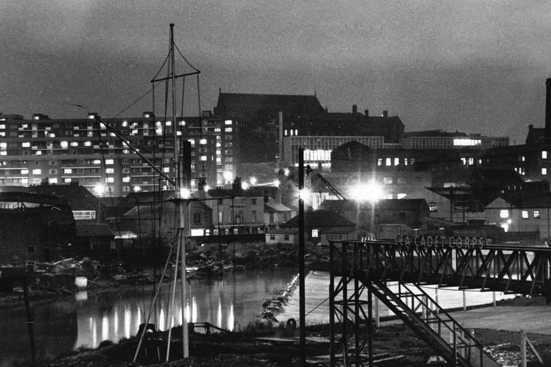 Looking from Crown Point Bridge across the River Aire towards the flats of Saxton Gardens in January 1966.