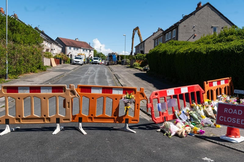 A cordon is in place in Mallowdale Avenue, where a suspected gas explosion killed a two-year-old boy and left two adults critically ill in hospital.