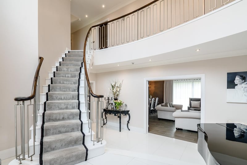 The light and spacious accommodation is arranged over 3 levels extending overall to some 7,000 sq. Ft and comprises a stone pillared entrance porch opening into a most impressive split level reception hallway with feature Corian curved staircase, minstrel gallery and a guest cloakroom.