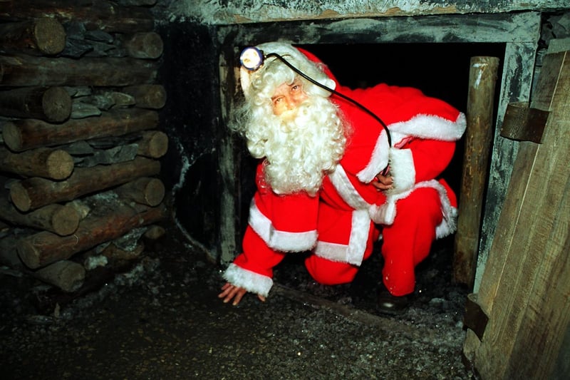 Father Christmas  - miner Brian Crossland - emerges from a tunnel underground at the National Mining Museum near Wakefield as Christmas Day approaches.