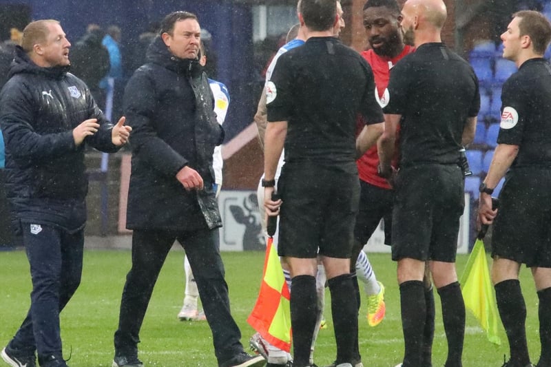 Morecambe manager Derek Adams greets the officials at full-time