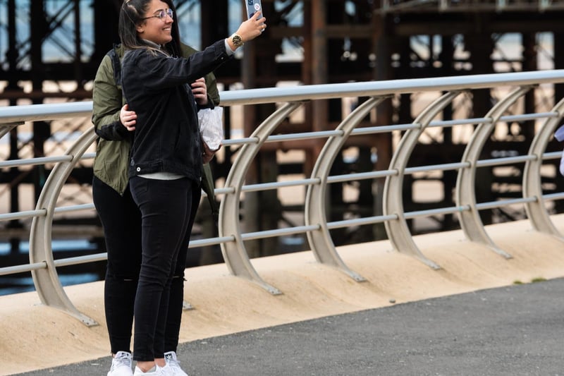 Two women take a selfie on Blackpool Promenade