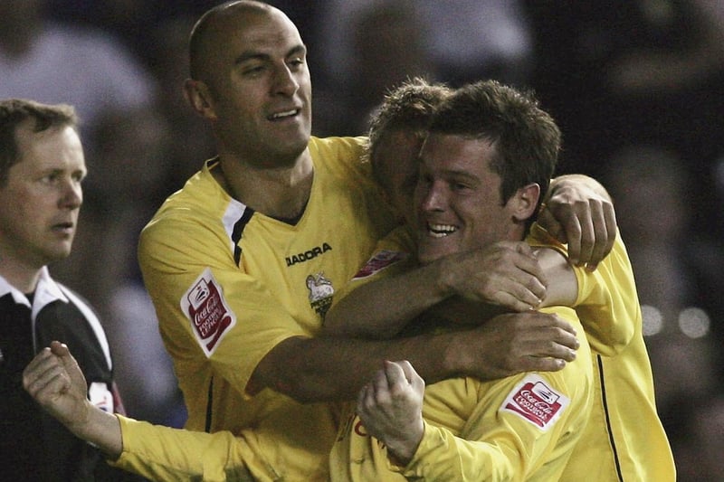 Preston North End striker David Nugent celebrates with Danny Dichio and Brett Ormerod after scoring the opening goal.