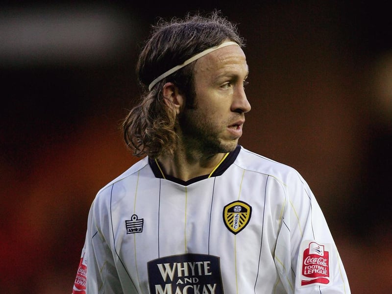 Midfielder Shaun Derry looks on.