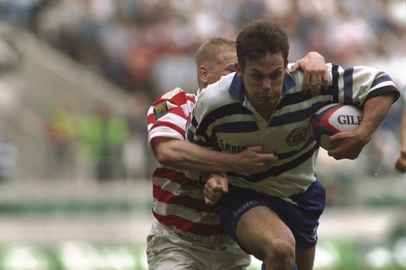 Ian Sanders (right) of Bath is tackled by a Wigan player during the Rugby Union leg of the clash of the codes. Photo: Mike Hewitt/Allsport