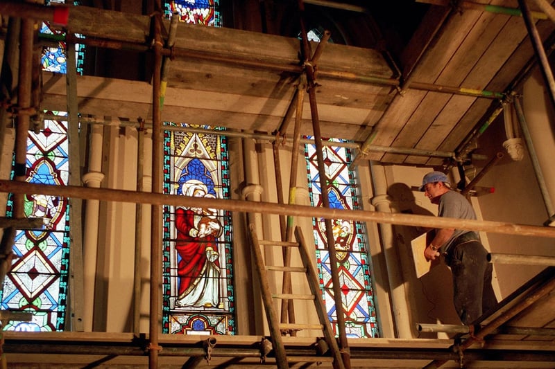 Tony Izett works on the plaster at St. Mary's Church in September 1998.