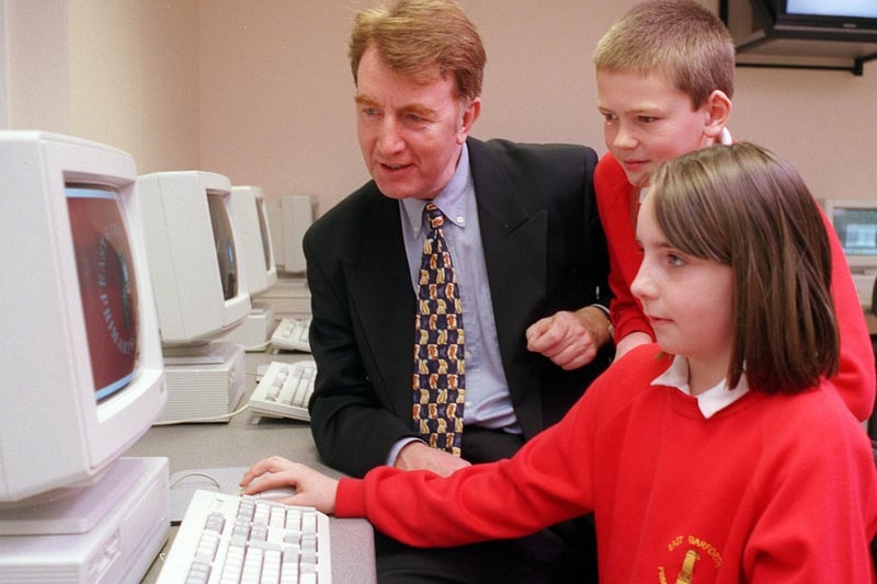 MP Colin Burgon is pictured with two pupils from East Garforth Primary in the school's new computer block.