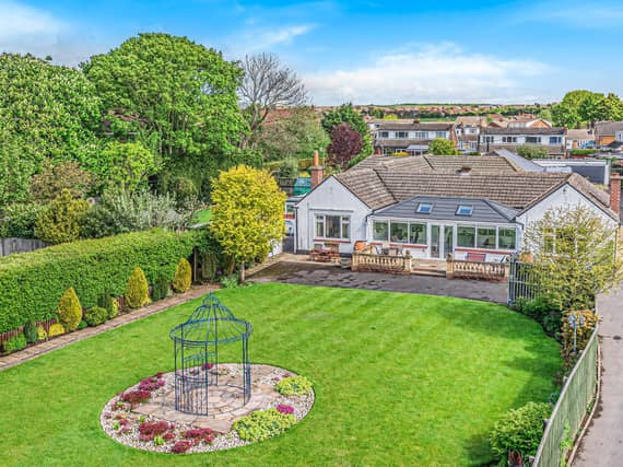 A view of the property and its lawned back garden