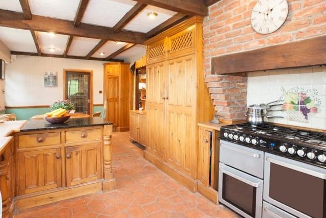The breakfast kitchen is a bright and airy room with stunning views overlooking the garden, range style cooker, exposed wooden beams and Terracotta tiled flooring.