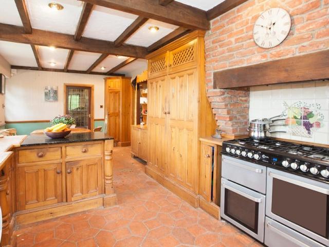 The breakfast kitchen is a bright and airy room with stunning views overlooking the garden, range style cooker, exposed wooden beams and Terracotta tiled flooring.