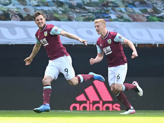 Chris Wood of Burnley celebrates with Ben Mee after scoring their side's third goal and his hat trick during the Premier League match between Wolverhampton Wanderers and Burnley at Molineux on April 25, 2021 in Wolverhampton, England.