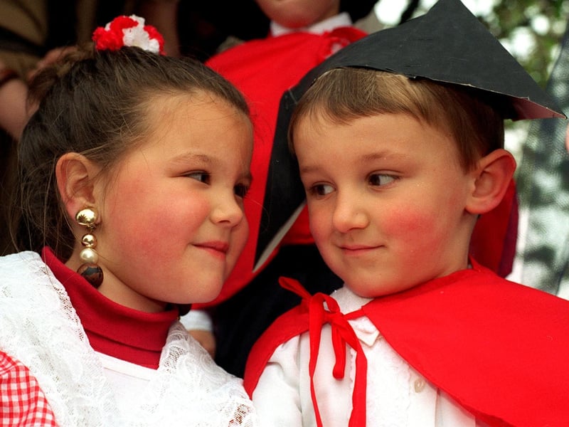Sharing a secret on the Pudsey Methodists float during the Carnival parade in May 1997 are Natalia Miller and Andrew Kemp.