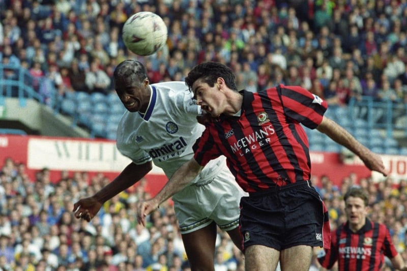Chris Whyte rises to head clear under pressure from Blackburn Rovers striker Mick Newell.