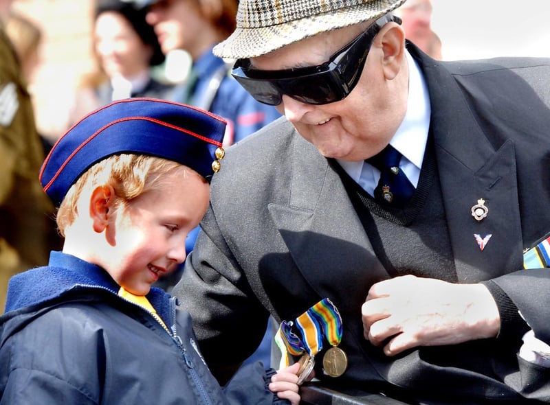 Boys Brigade member Charlie Gregory, left, admires the medals of the President of Standish Royal British Legion George Richards before the VE Day parade in Standish on Sunday 8th of May 2005.